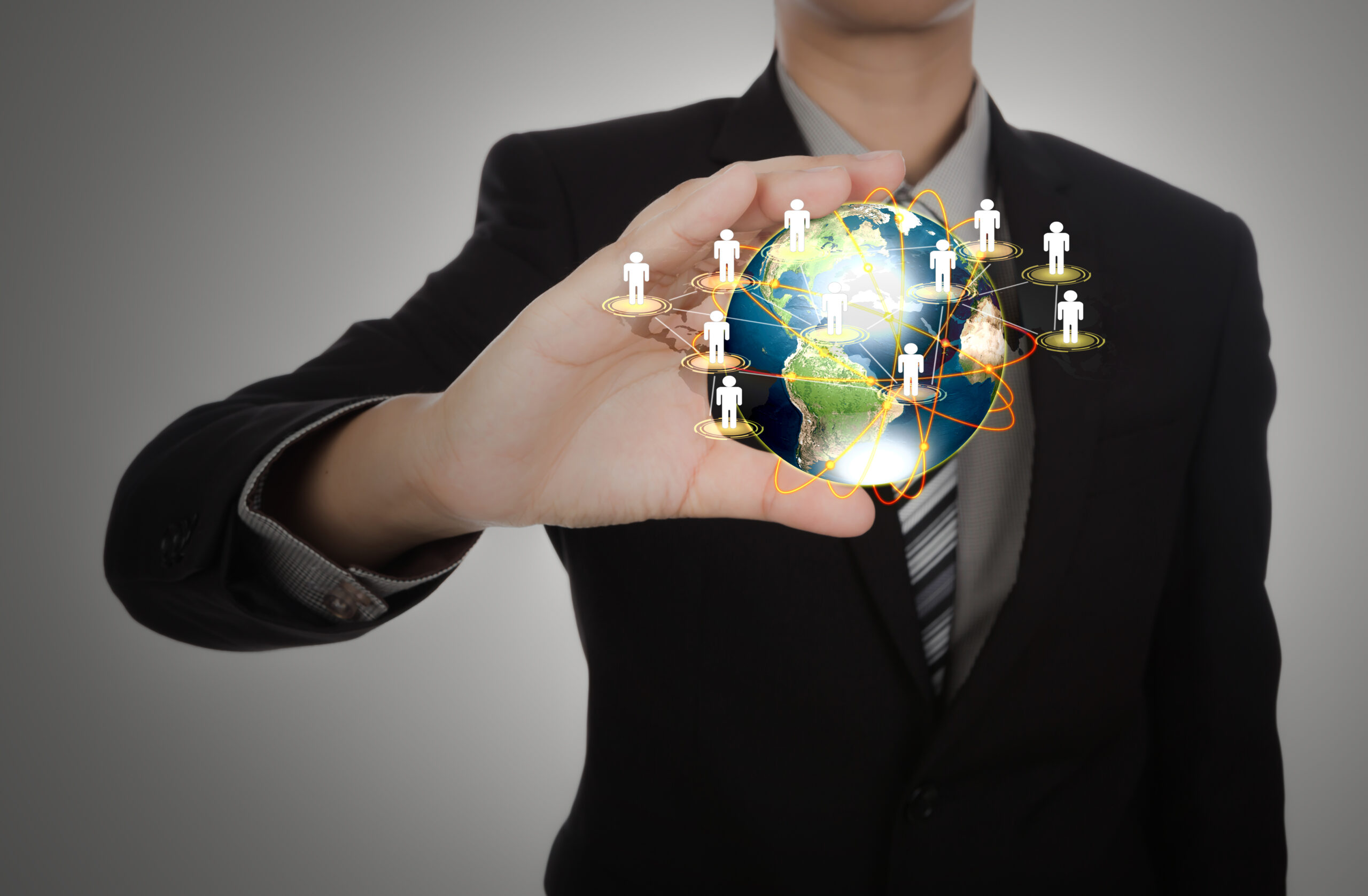 About Us business man holding the small world in his hands against white